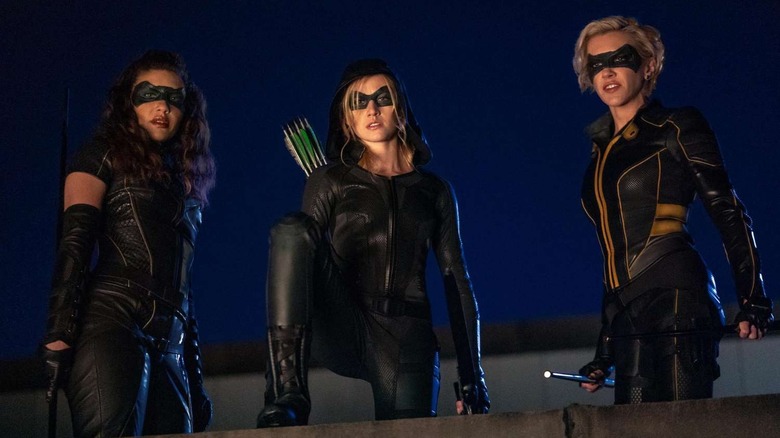 Dinah Drake (Juliana Harkavy), Mia Queen (Katherine McNamara), and Laurel Lance (Katie Cassidy) look down from a rooftop in Arrow