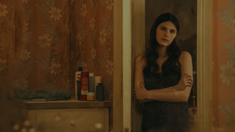 Leanne standing in doorway with arms crossed