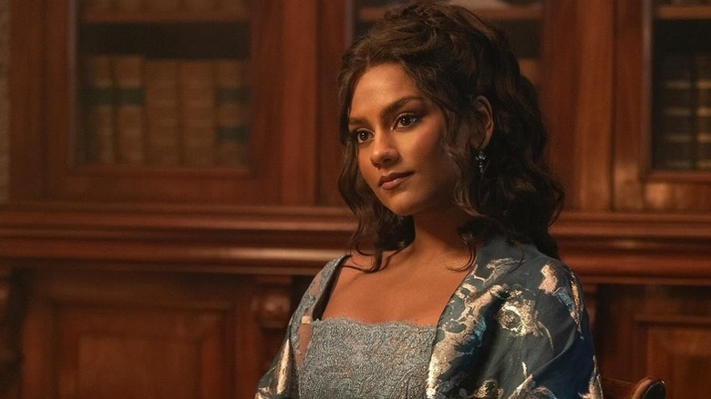 Kate Bridgerton (Simone Ashley) stands in a study in her pajamas in Bridgerton