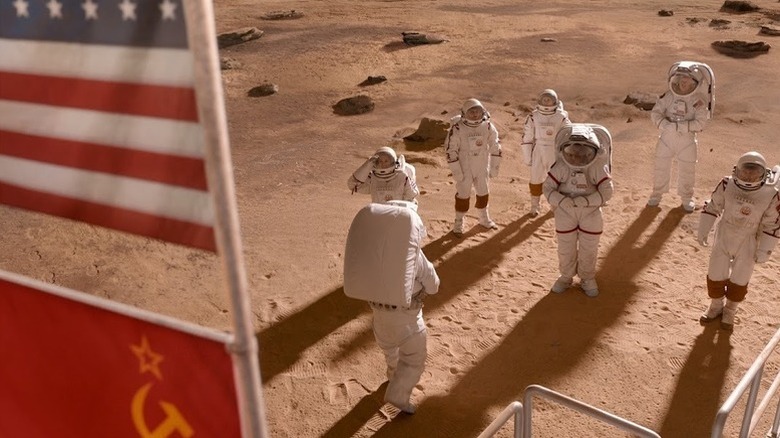 Astronauts gather under flying American and Soviet flags on Mars in For All Mankind