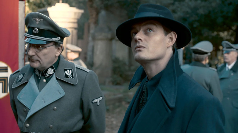 Douglas Archer (Sam Riley) looks inquisitively up next to Nazi officers in SS-GB