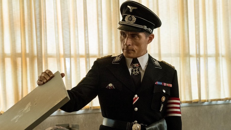 SS Obergruppenführer John Smith (Rufus Sewell) opening a box in The Man in the High Castle