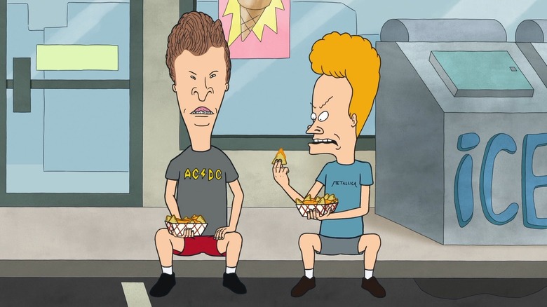 Beavis (Mike Judge) angrily studies a nacho sitting on a curb with Butt-Head (Mike Judge) in Beavis and Butt-Head