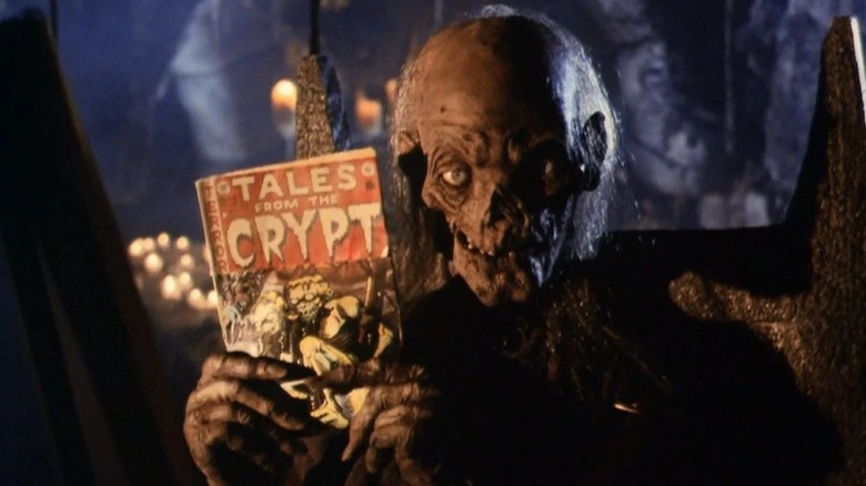 The Cryptkeeper holds up a comic book in Tales from the Crypt