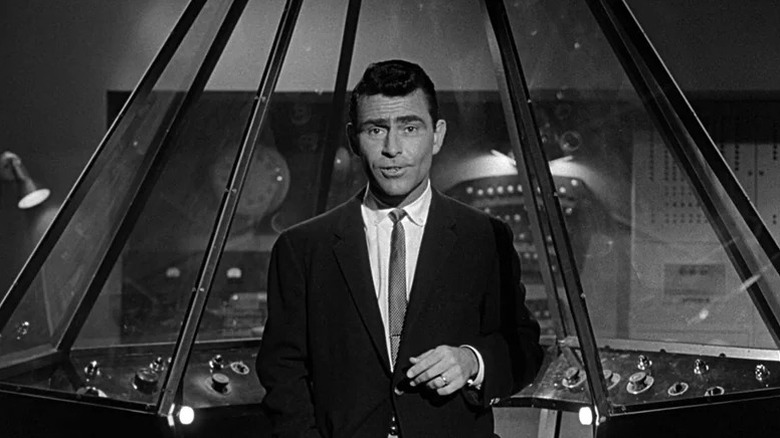 Rod Serling speaks to the camera while standing in front of a futuristic console in The Twilight Zone (1959)