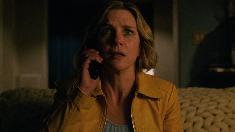 Rhea Seehorn as Carol Sturka looking scared on the phone in Pluribus