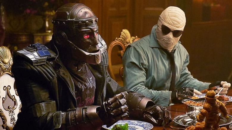 Robotman and Negative man sit at a dinner table in Titans