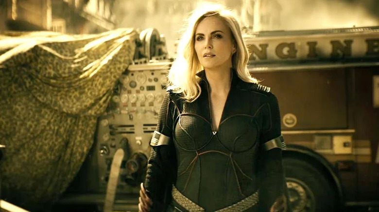 Charlize Theron in Stormfront's costume stands by a firetruck in The Boys