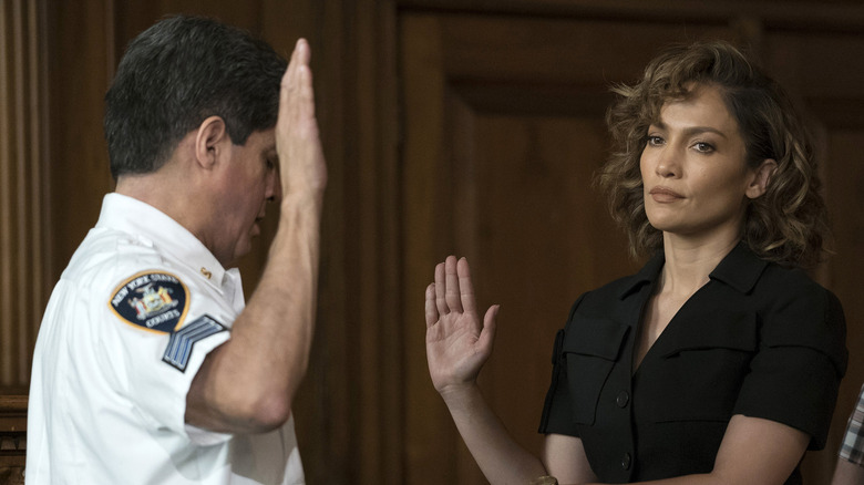 Harlee Santos (Jennifer Lopez) unenthusiastically raises her hand to swear an oath in Shades of Blue