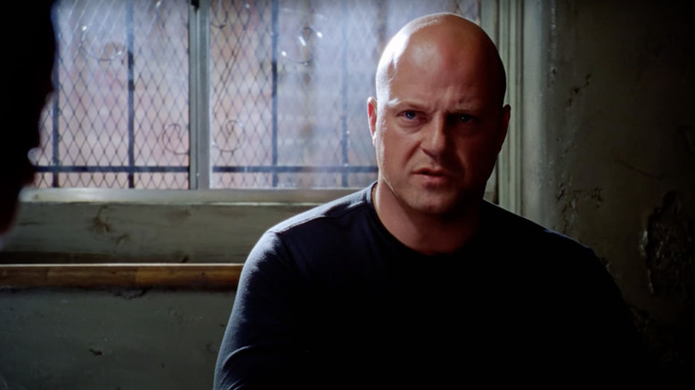 Vic Mackey (Michael Chiklis) speaks tensely by a window in The Shield