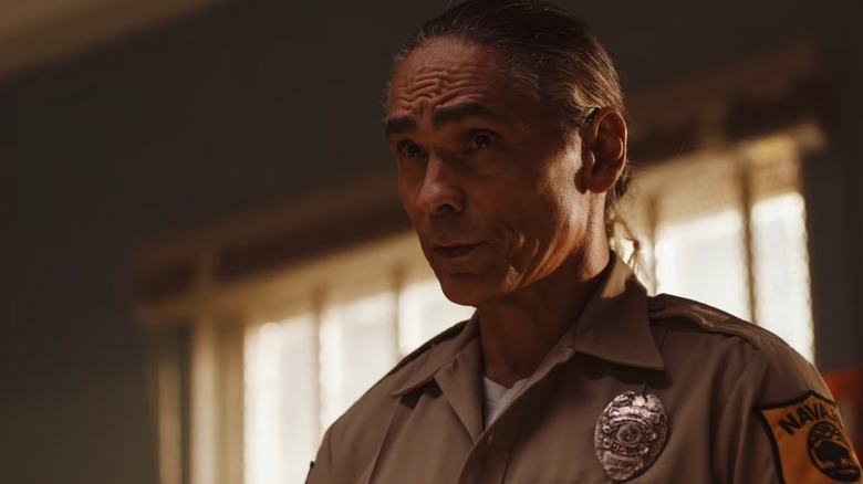 Joe Leaphorn (Zahn McClarnon) looks up sternly in his office in Dark Winds