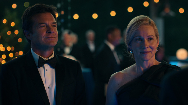Marty Byrde (Jason Bateman) and Wendy Byrde (Laura Linney) in formal wear smile at a gala in Ozark