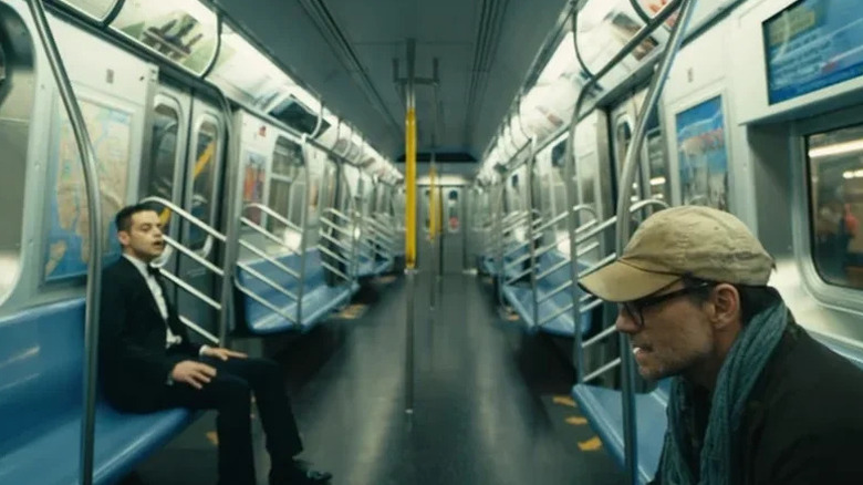 Elliot Alderson (Rami Malek) stares at Mr. Robot (Christian Slater) while riding an empty subway car in "Mr. Robot."