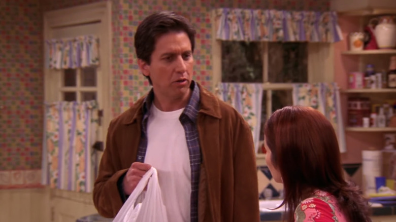 Ray Romano as Ray Barone holds a plastic bag in Everybody Loves Raymond