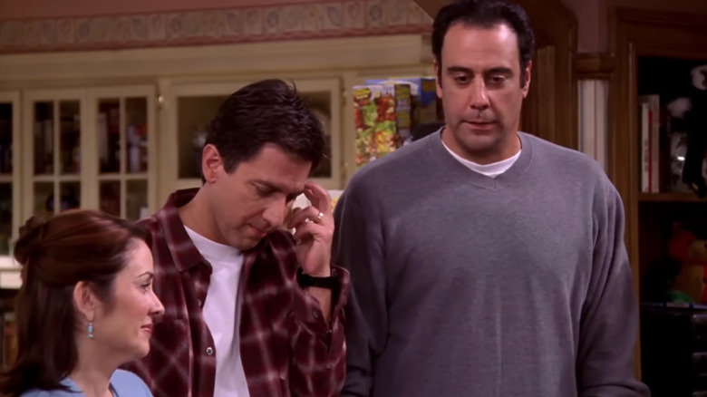 Patricia Heaton as Debra Barone stands next to Ray Romano as Ray Barone and Brad Garrett as Robert Barone in Everybody Loves Raymond