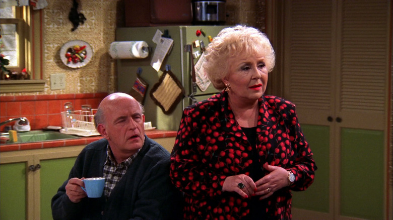 Peter Boyle as Frank Barone sips coffee next to Doris Roberts as Marie Barone in Everybody Loves Raymond