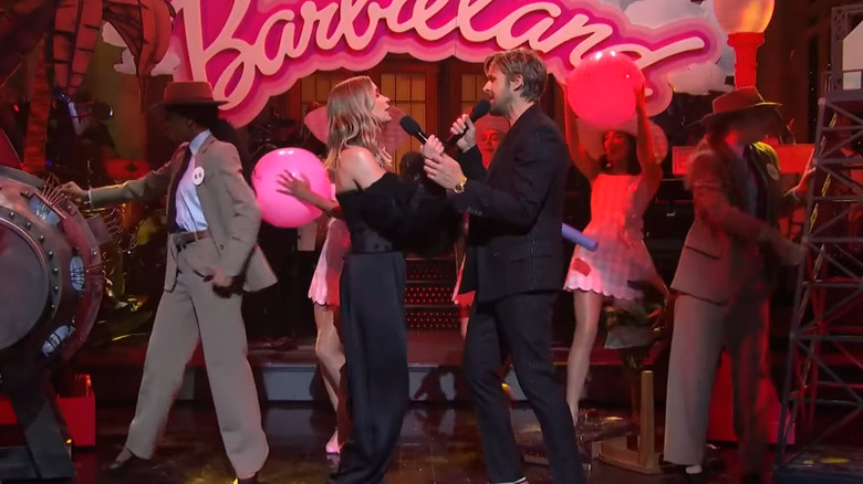 Emily Blunt and Ryan Gosling sing a duet with props from Barbie and Oppenheimer on SNL.