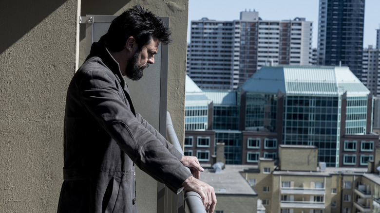 Billy Butcher (Karl Urban) standing on a balcony in The Boys