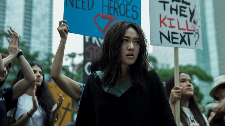 Kimiko (Karen Fukuhara) stands in front of protestors in The Boys