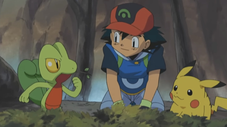 Treecko, Ash, and Pikachu inside a tree in the Pokemon anime