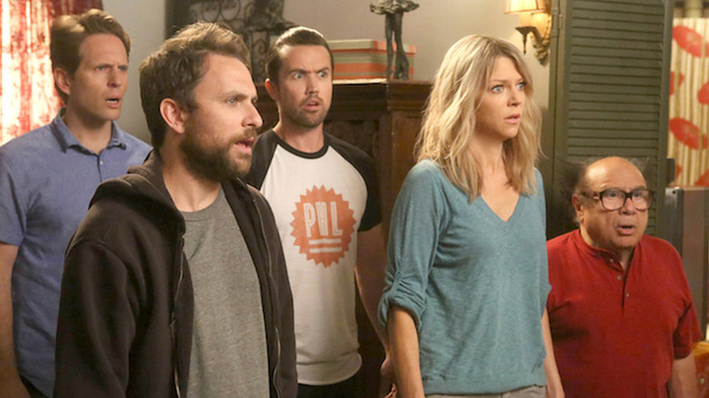 Dennis, Charlie, Mac, Dee, and Frank looking shocked