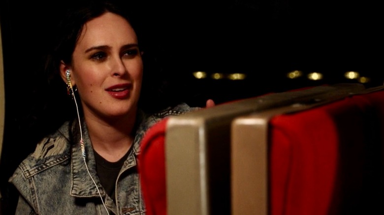 Georgia seated in a train, speaking