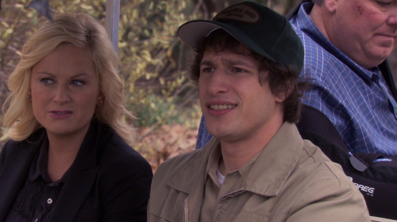 Amy Poehler as Leslie Knope sitting next to Andy Samberg as Carl Lorthner in Parks & Recreation