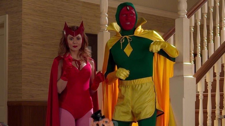 Elizabeth Olsen as Wanda Maximoff and Paul Bettany as Vision, dressed for Halloween in WandaVision.