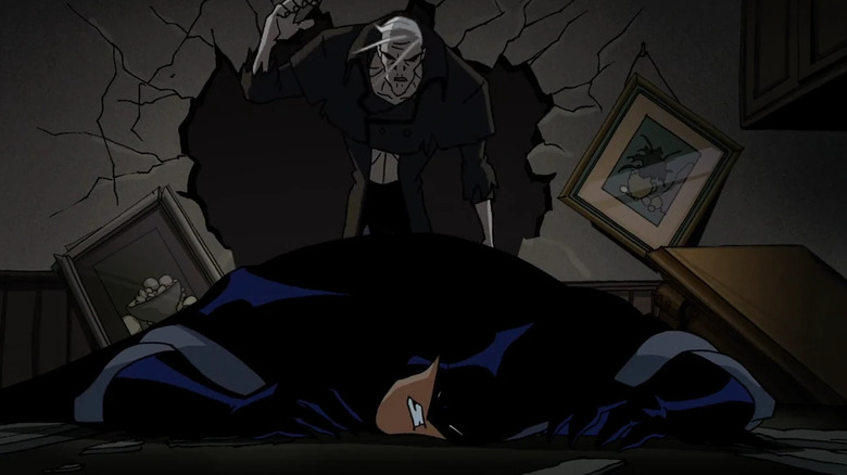 Grundy walks toward Batman through a hole in the wall in The Batman.