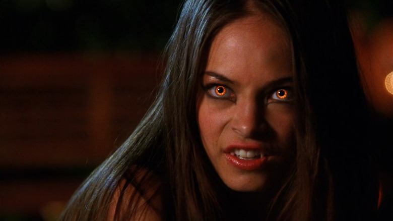 Kristin Kreuk as Lana Lang, with red eyes and vampire fangs in Smallville.