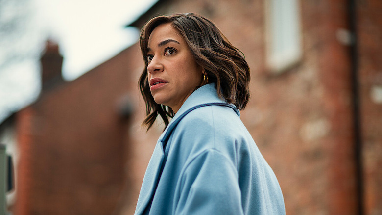 Megan Pierce (Cush Jumbo) looks over her shoulder in a street in Stay Close