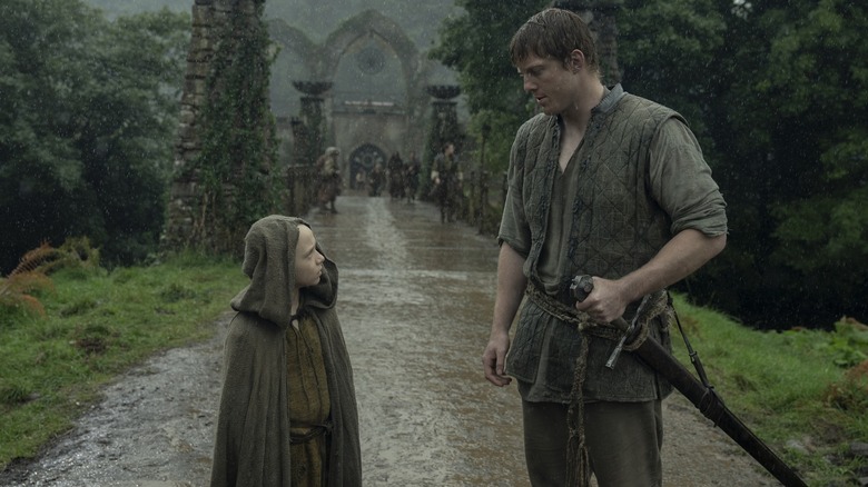 Dexter Sol Ansell as Egg with bald head wearing cloak next to Peter Claffey as Durk with sword in A Knight of the Seven Kingdoms