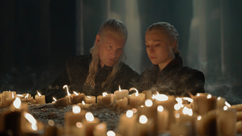 Matt Smith as Daemon Targaryen and Emma D'Arcy as Rhaenyra Targaryen with candles in front of them in House of the Dragon