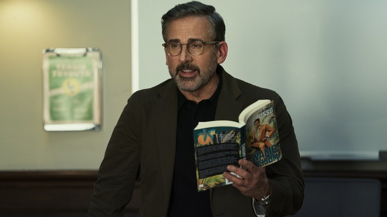 Steve Carell as Greg Russo holding book in Rooster