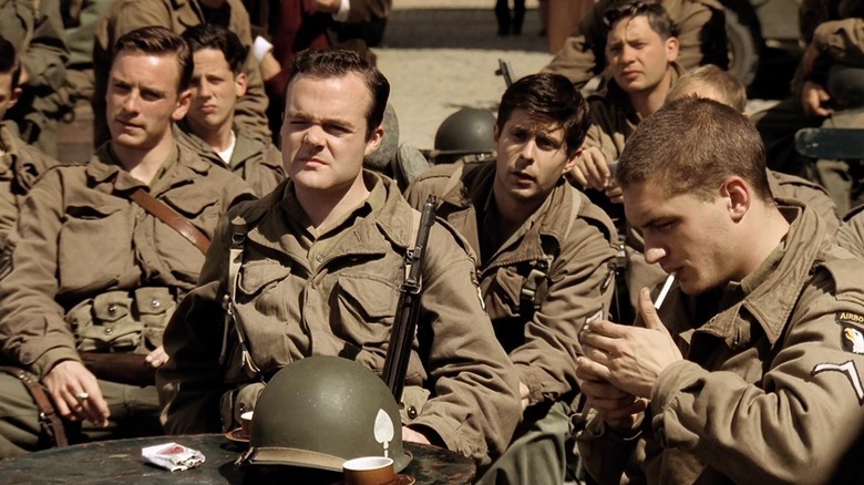 Michael Fassbender as Burton, Matt Hickey as Patrick, Rick Gomez as George, Dexter Fletcher as Johnny, and Tom Hardy as John sitting around in Band of Brothers