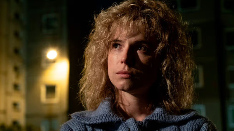 Jessie Buckley as Lyudmilla standing outside at night in "Chernobyl."
