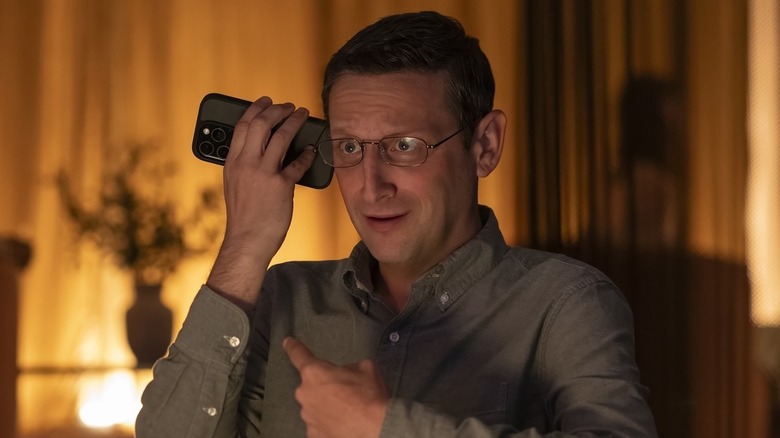 Tim Robinson as Ron holding a phone up to his ear in "The Chair Company."