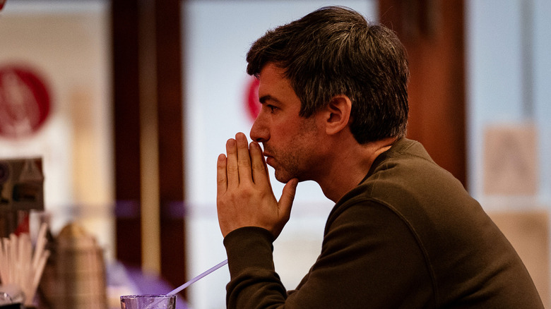 Nathan Fielder sitting by himself at a bar in "The Rehearsal."