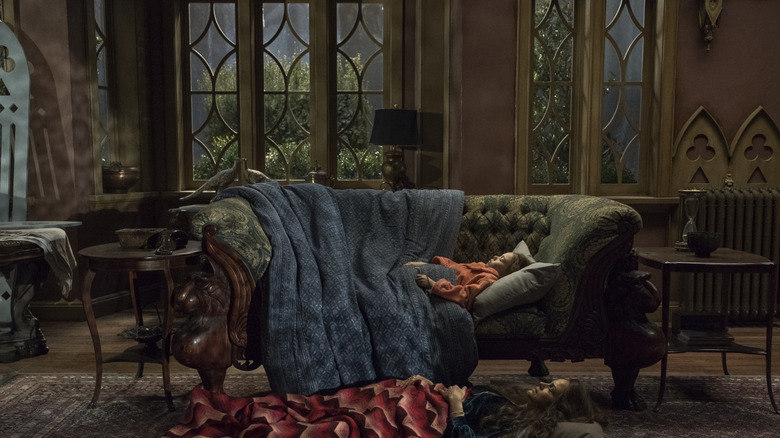 Young Nell sleeps on couch with mother on the ground at her side