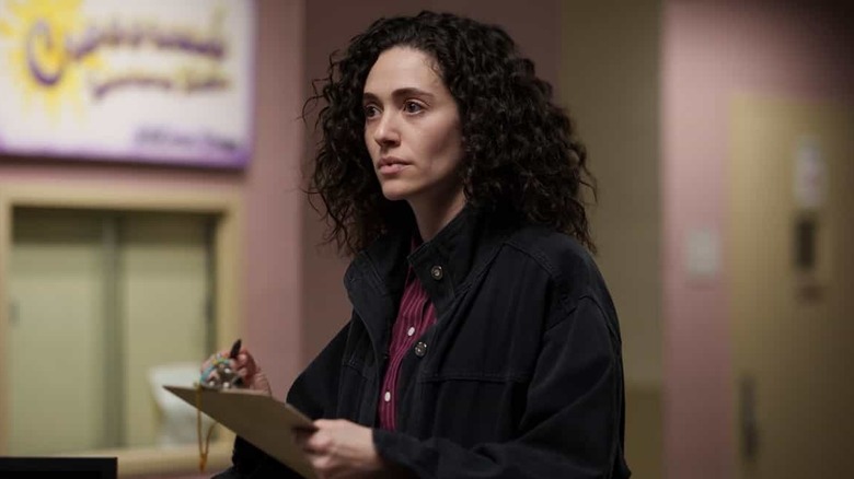 Emmy Rossum as Alice Black, holding a clip board in Furious.