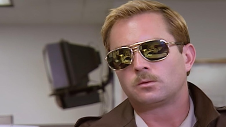 Lt. Dangle wearing sunglasses indoors in Reno 911
