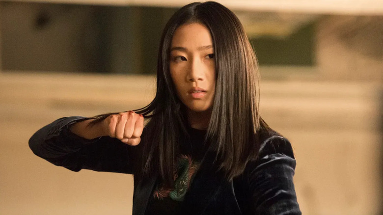 Nicky Shen (Olivia Liang) raises a bloodied fist in Kung Fu