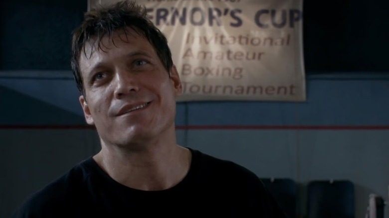 A sweaty Patrick "Lights" Leary (Holt McCallany) stands in a gym under a banner in Lights Out
