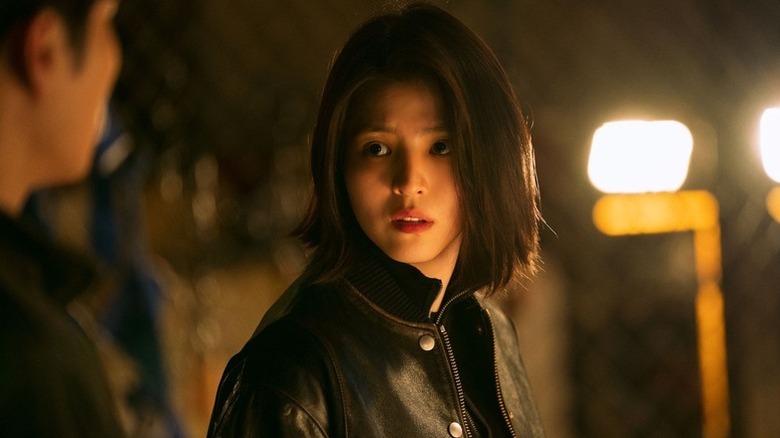 Yoon Ji-woo (Han So-hee) looks at a colleague in a dark room in My Name