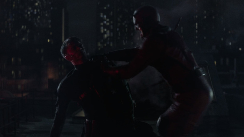 Wilson Bethel as Bullseye being beaten up by Charlie Cox as Daredevil on a roof in Daredevil: Born Again