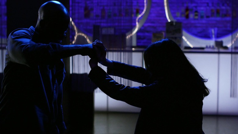 Krysten Ritter as silhouetted Jessica Jones fighting a silhouetted Mike Colter as Luke Cage in Jessica Jones