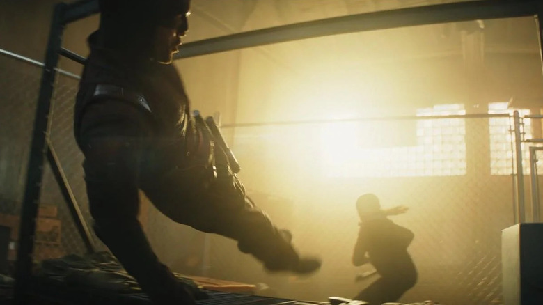 Charlie Cox as Daredevil jumping away from Alaqua Cox as Maya Lopez's silhouette in Echo