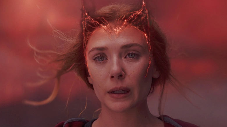 Elizabeth Olsen as Wanda with a Scarlet Witch crown forming on her head in WandaVision