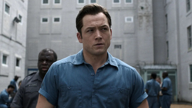 Taron Egerton as James "Jimmy" Keene, walking through the prison yard in Black Bird.