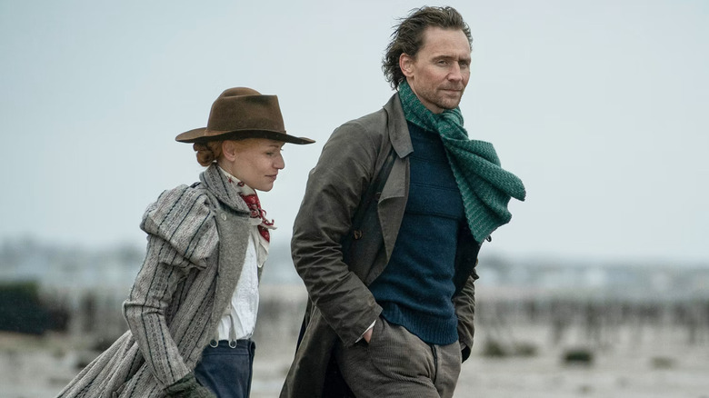 Claire Danes as Cora Seaborne and Tom Hiddleston as Will Ransome, walking together in the wind in The Essex Serpent.